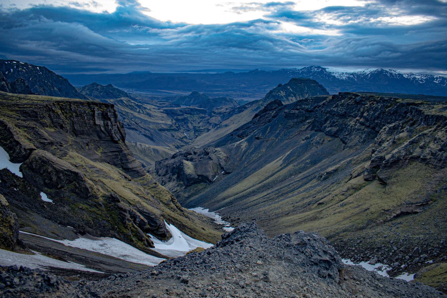 Wide view down a mountain valley at dusk